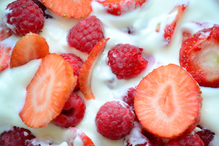 Strawberries and raspberries in yogurtの写真素材