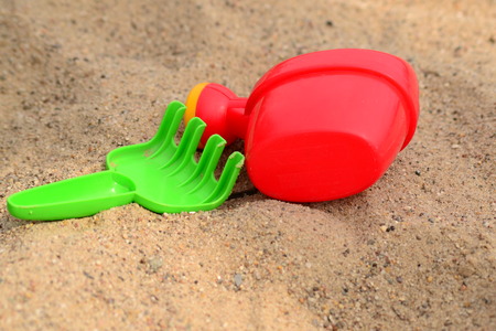 plastic toys lying on the sandの写真素材