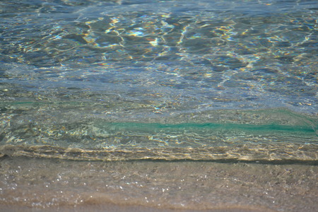 clear, clean water on a sandy seashoreの写真素材