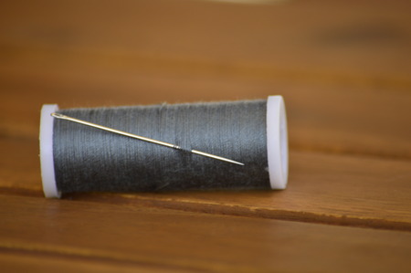 coil gray thread with a needle