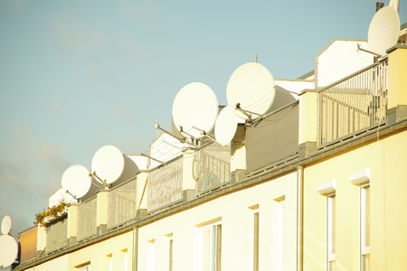 Satellite dishes on the roof of an apartment houseの写真素材