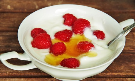 yogurt with raspberries and honeyの写真素材