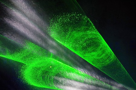 Rays of light green and white on a black backgroundの写真素材