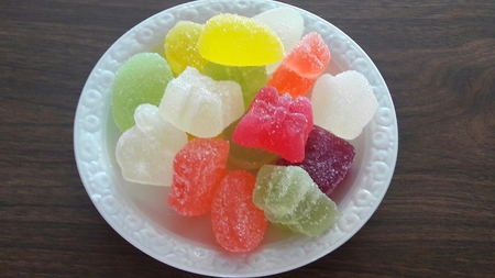 jujube colored sweet on a white saucer
