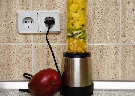 Metal blender for smoothies with fruit insideの写真素材