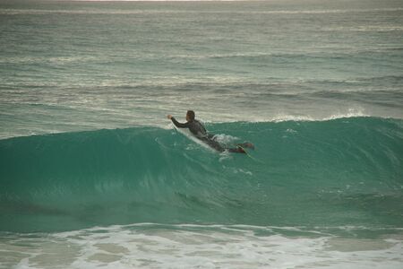 Surfer on a board on a high wave