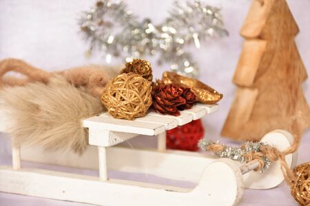 Wooden sledges and Christmas decorations on a white backgroundの写真素材