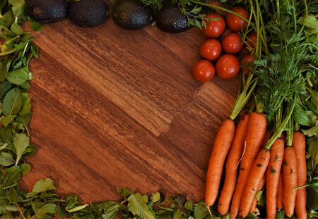 Vegetables on a wooden background for a pattern or backgroundの写真素材