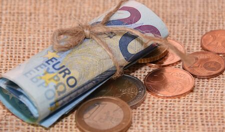 Euro banknotes and coins close-up on a natural canvas