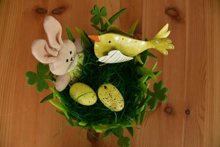 Easter decorations, hare, chicken and eggs in a green basket