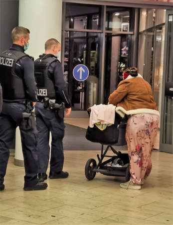 berlin germany, november, 2020 two police officers arrest a woman with a pram