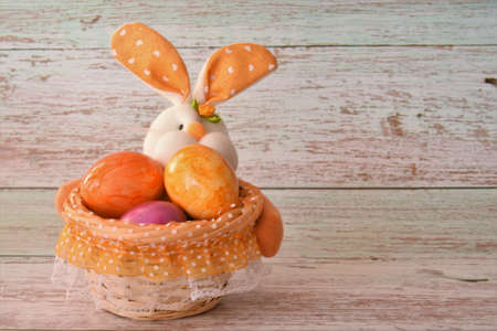 bunny with Easter eggs in a basketの写真素材