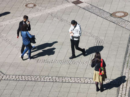 Berlin germany april 2021, young people walk down the street wearing medical masks on the street in charlottenburgのeditorial素材