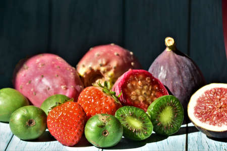 fresh eusotic berries on a blue wood tableの写真素材