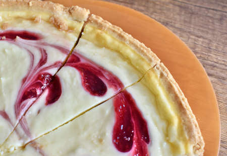 Close-up of a cherry pie on a plate on a wooden tableの写真素材