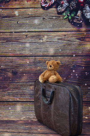 vintage leather suitcase and teddy bear on a wooden backgroundの写真素材