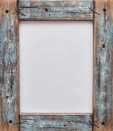 old scratched wooden frame stands on a wooden table