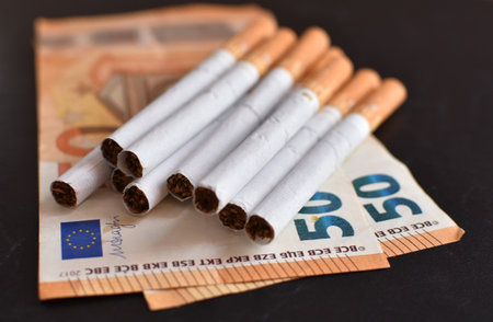 50 euro banknote and cigarettes on a black backgroundの写真素材