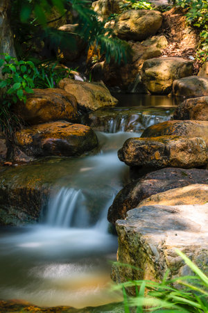 Small waterfall in the forest, Thailand. (Selective focus)の写真素材