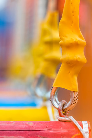 Close-up of rope on a carabiner with orange rubber bootsの写真素材