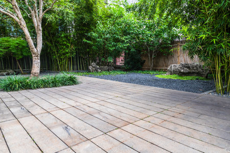 Wooden floor in the garden with green trees and grass background.の写真素材