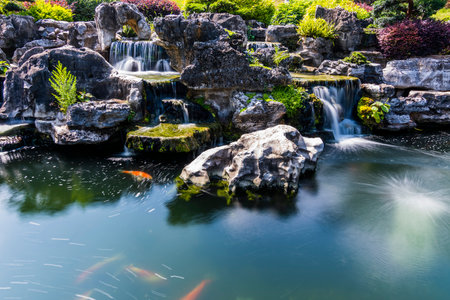 Beautiful luxury Japanese garden with pond and waterfall in the city parkの写真素材