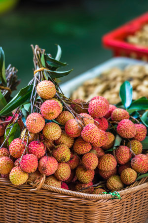 Fresh lychees in a wicker basket on the market.の写真素材