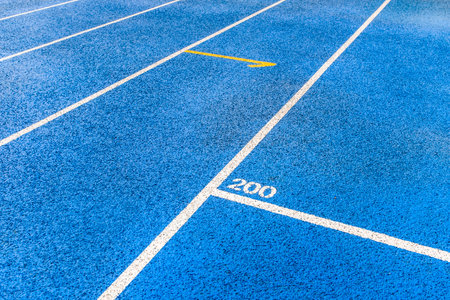 Running track number 2020 on blue plastic sport track and white line.の写真素材