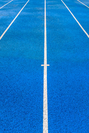 Running track with white line on blue color, sport background and texture