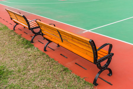 Wooden bench in the park, closeup of photo with soft focusの写真素材