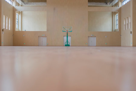 Interior of a fitness hall with a wooden floor and a green standの写真素材
