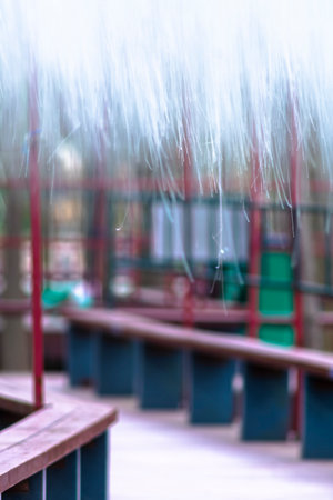 Rain drops falling on the playground. Blurred background with copy space.の写真素材