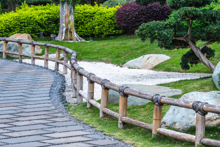 Wooden walkway in the garden with stone pathway, Thailand.の写真素材