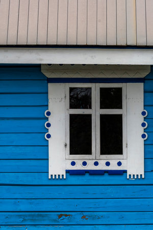 Old blue wooden house with white window on a blue wall in Icelandの写真素材