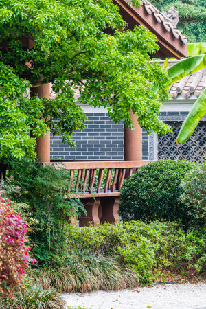 Balcony in the garden with green leaves and brick wall.の写真素材