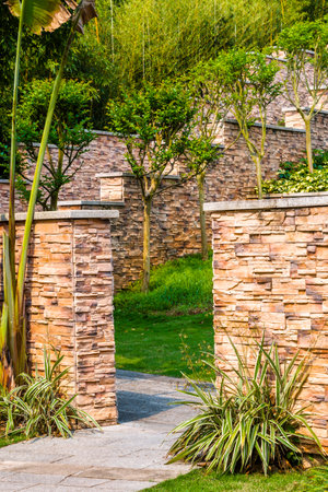 Luxury garden with stone wall and green plants, Thailand.の写真素材