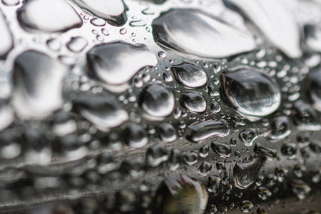 Water drops on a metal surface. Close-up. Macro.