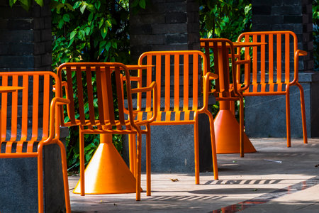 Orange chairs in the park, Bangkok, Thailand. Selective focus.の写真素材