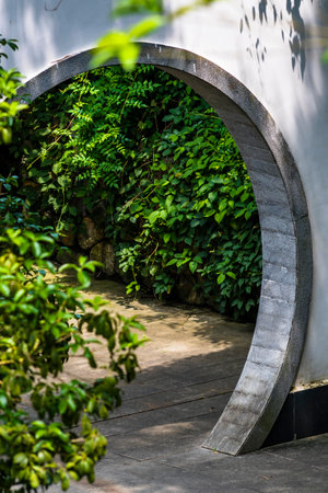Green wall and stairs in the park with a round wooden arch.の写真素材