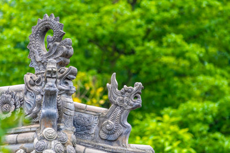 Dragon statue on the top of the Chinese temple in the garden.の写真素材