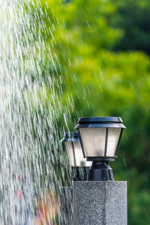 Lantern under the rain with blurred green background, stock photoの写真素材