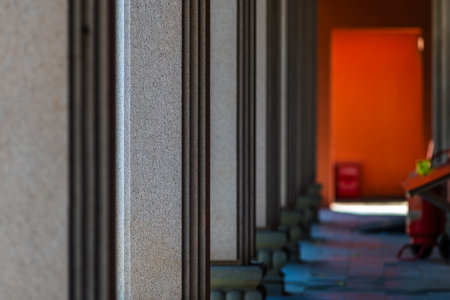 Close up of an old stone wall with a red door in the backgroundの写真素材
