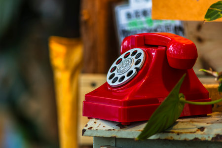 Old red telephone on the wooden background, vintage style, selective focusの写真素材