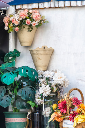 Flowers in vases on the white wooden wall with copy spaceの写真素材