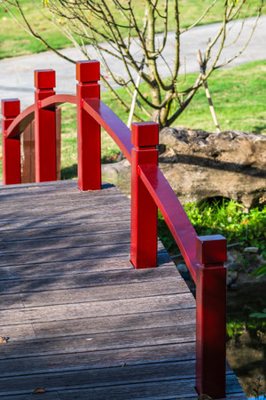 Red bridge in the park. The bridge is made of wood.の写真素材