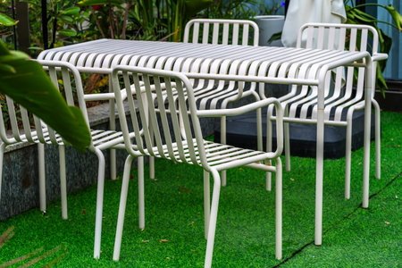 White plastic chair in the garden with green grass background, stock photoの写真素材