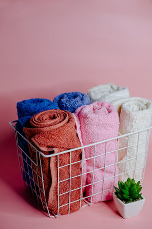 multicolored terry towels in a white basketの写真素材