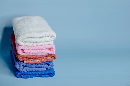 multicolored terry towels on a blue backgroundの写真素材