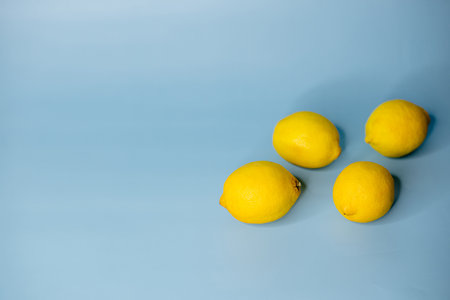 yellow lemons lie on a blue background
