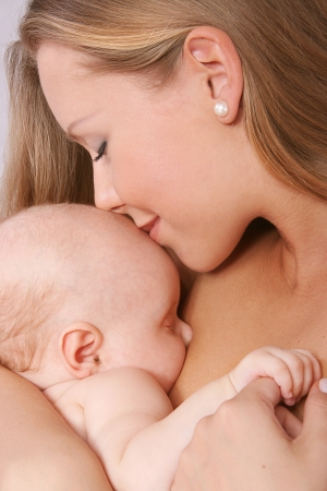 mother kissing her child の写真素材